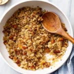 Golden homemade bread and crumbs spilling from a wooden bowl